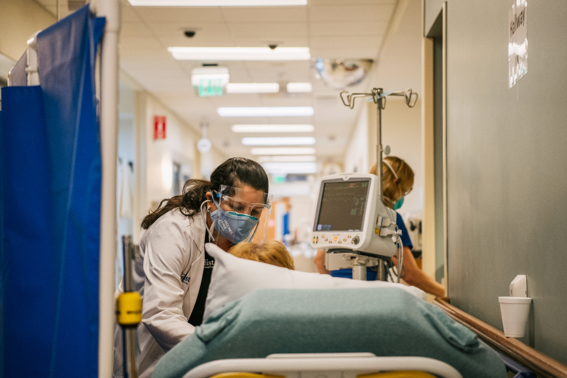 Healthcare professionals working in a hospital corridor demonstrating the need for balanced security and patient care