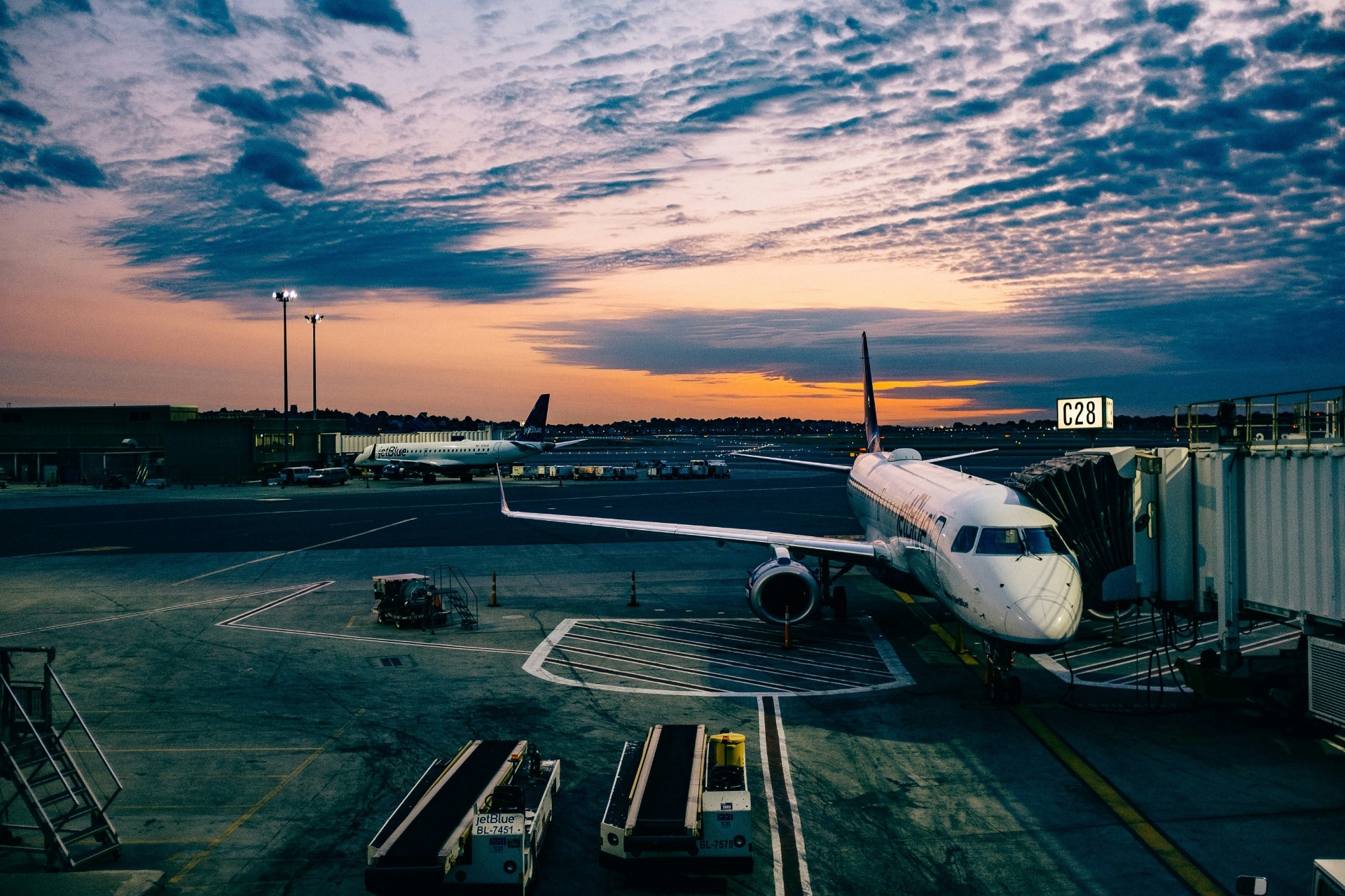 Airport terminal with aircraft at gate during sunset, showing transportation hub security monitoring