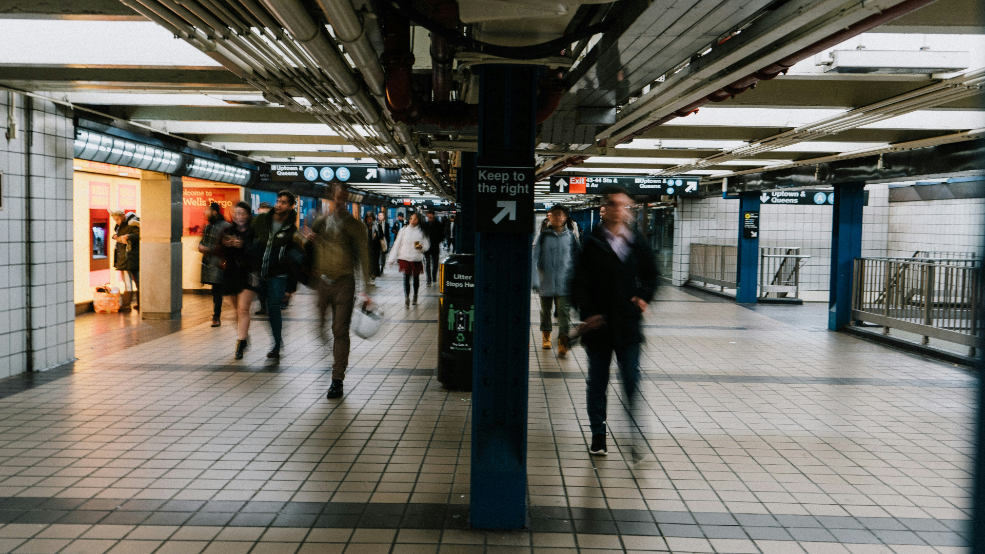 Busy subway station with commuters and public transportation infrastructure